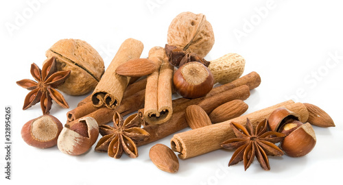 isolated image of anise, walnuts, cinnamon sticks on white background close-up