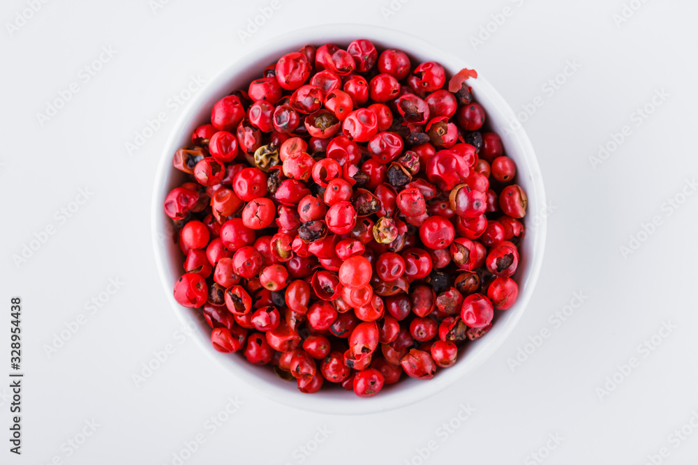 fragrant pink peppercorns on white acrylic background fragrant pink peppercorns on white acrylic background