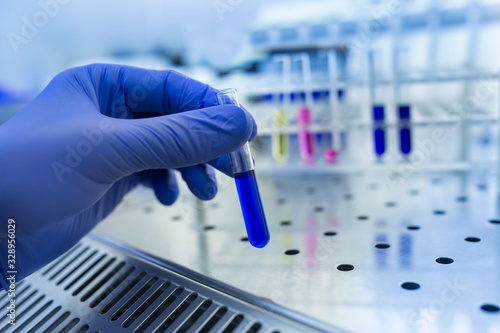 Biologist holding test tube with chemicals