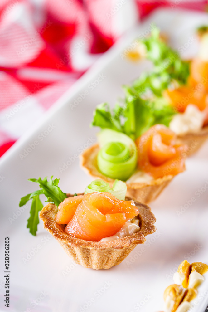 delicious snack tartlets on rustic wooden background delicious snack tartlets on rustic wooden background