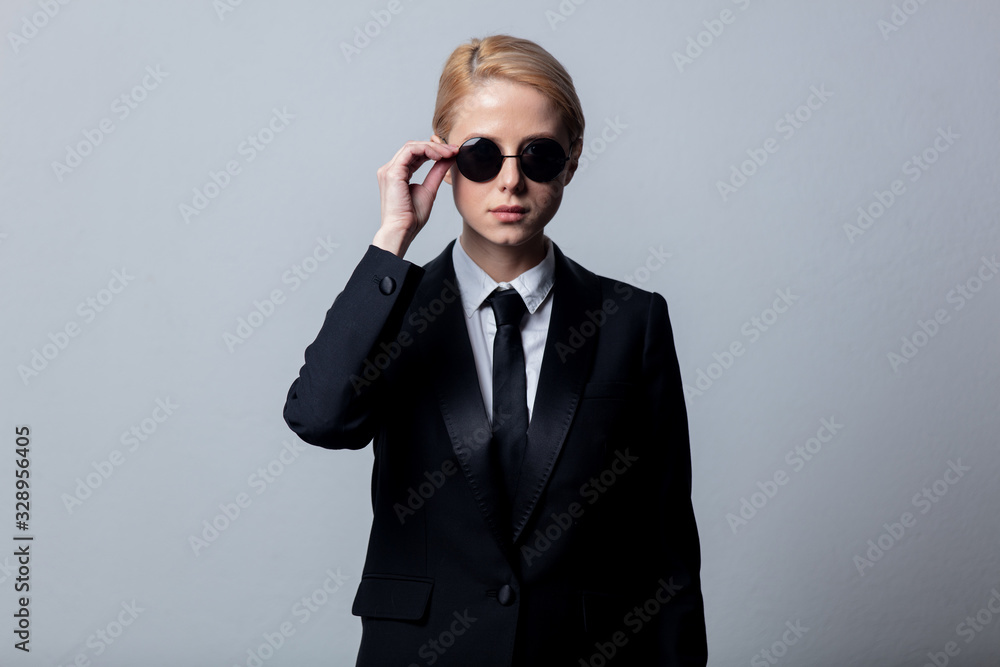 Style businesswoman in a classic black business suit and sunglasses - obrazy, fototapety, plakaty 