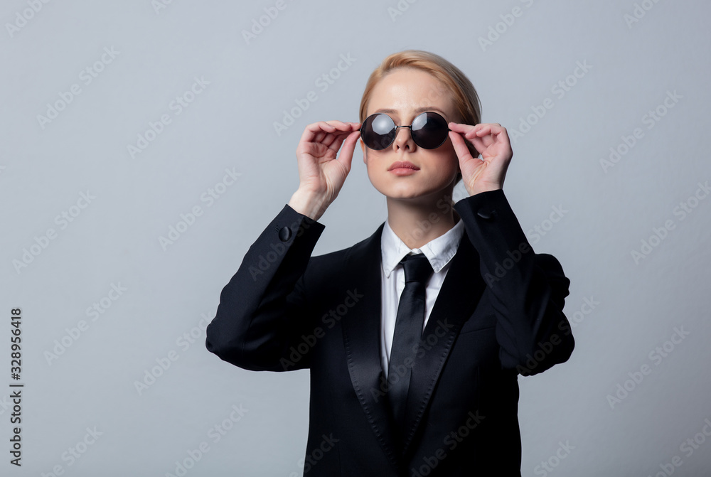 Style businesswoman in a classic black business suit and sunglasses Style businesswoman in a classic black business suit and sunglasses
