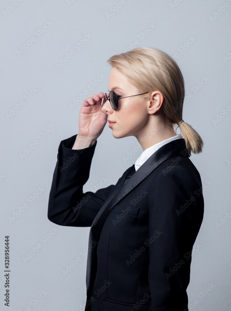 Style businesswoman in a classic black business suit and sunglasses Style businesswoman in a classic black business suit and sunglasses