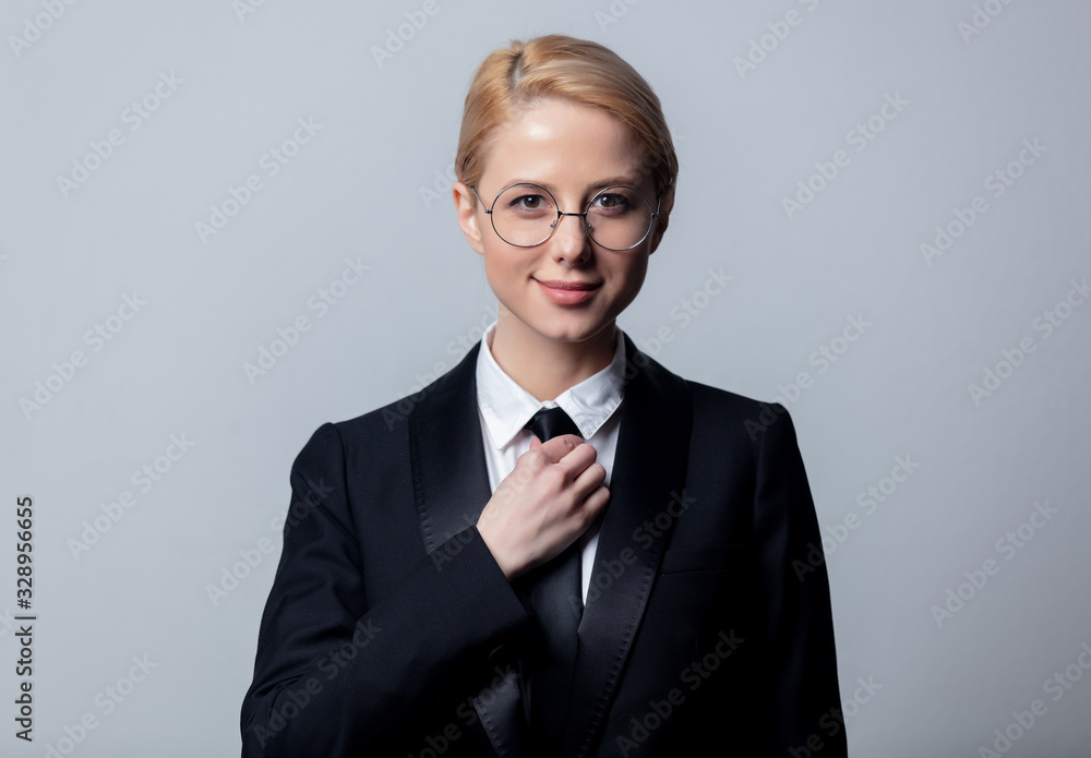 businesswoman in a classic black business suit and glasses businesswoman in a classic black business suit and glasses