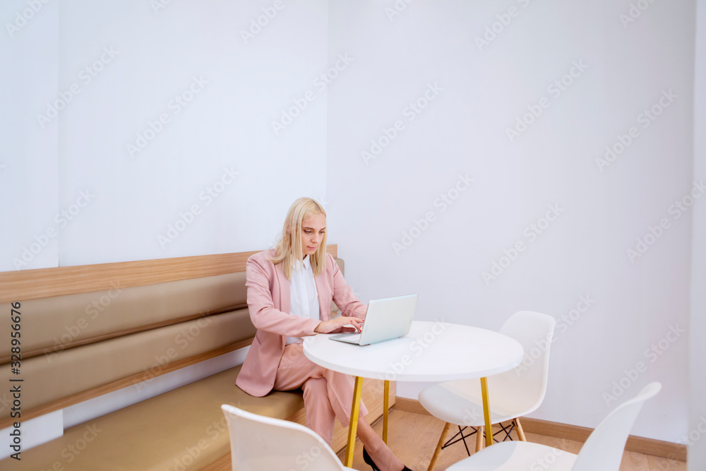Woman working on her laptop in the coworking space