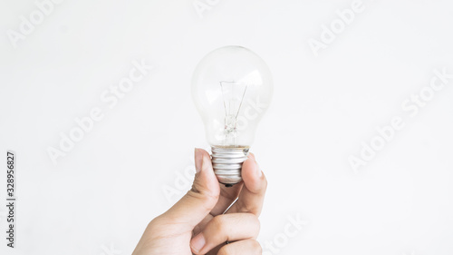 Closeup of hand holding light bulb