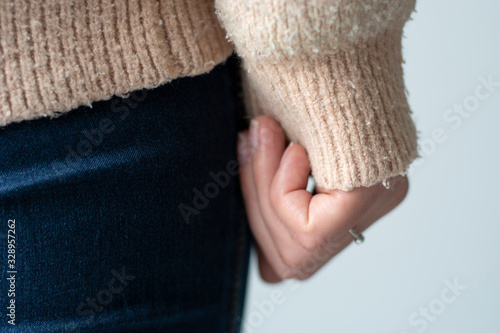 Pilled sweater. Closeup woman wearing a old used sweater with lint (pilling).  photo