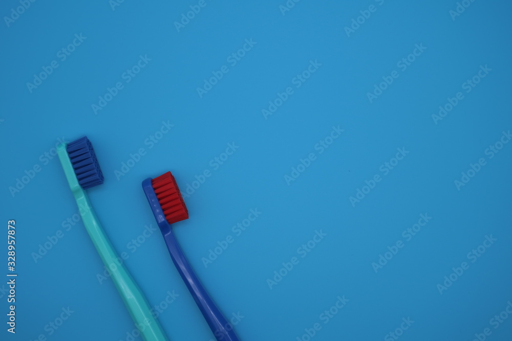 Tooth brushes on blue background Tooth brushes on blue background