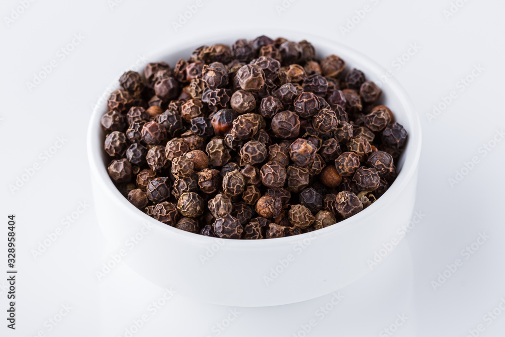 fragrant black pepper on white acrylic background fragrant black pepper on white acrylic background