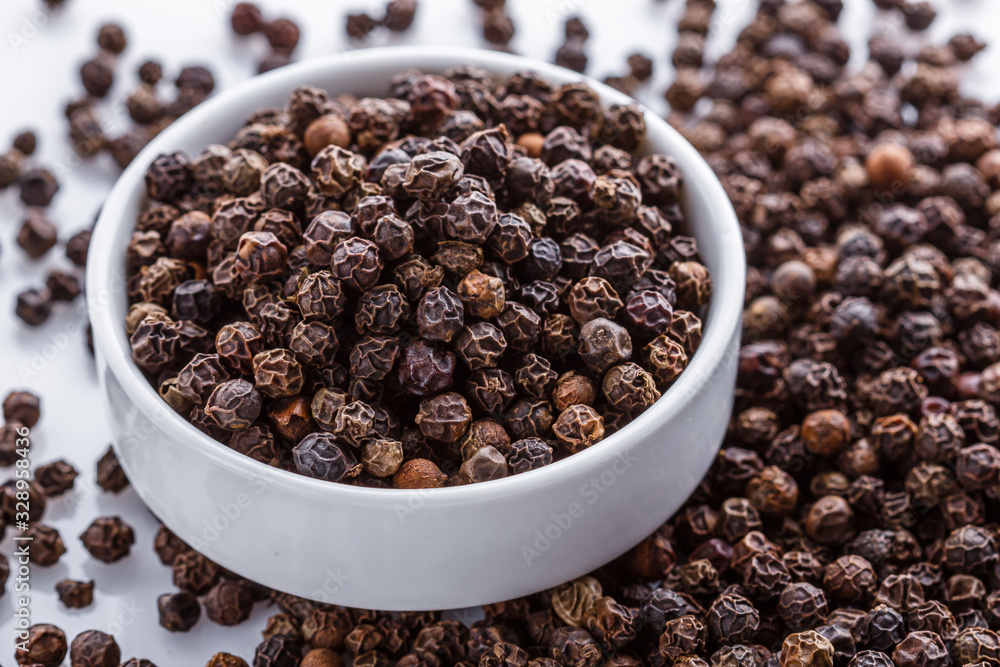 fragrant black pepper on white acrylic background fragrant black pepper on white acrylic background