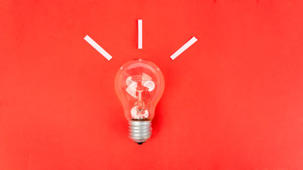 Top view of light bulb on red background