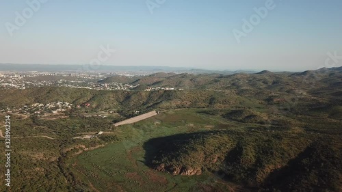 4K aerial drone video of greeen savanna hills and Avis Dam near historical railway bridge on main B6 road from Windhoek to Gobabis in central highland Khomas Hochland of Namibia, southern Africa photo