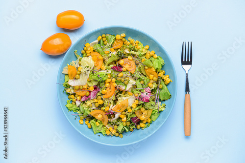 Bowl with tasty salad on color background