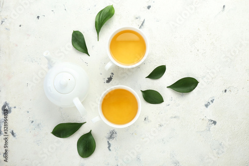 Cups of hot tea on white background