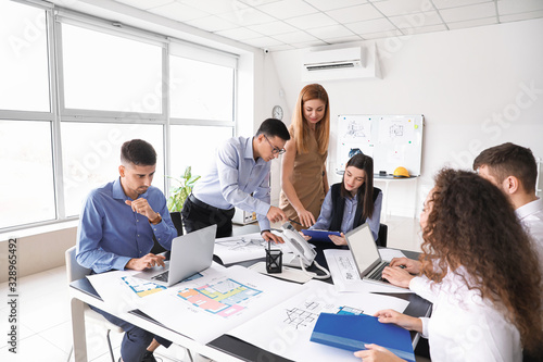 Architect teaching young pe...