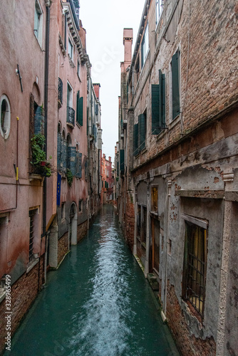 Narrow Canal mirroring the surrounding Houses, Venice/Italy