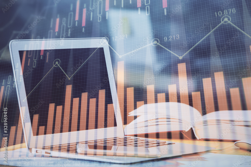 Forex graph hologram on table with computer background. Double exposure. Concept of financial markets. Forex graph hologram on table with computer background. Double exposure. Concept of financial markets.