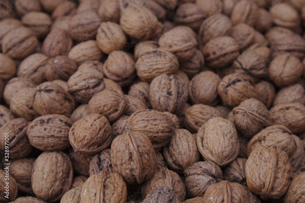 Close-up of a pile of unpeeled walnuts Close-up of a pile of unpeeled walnuts