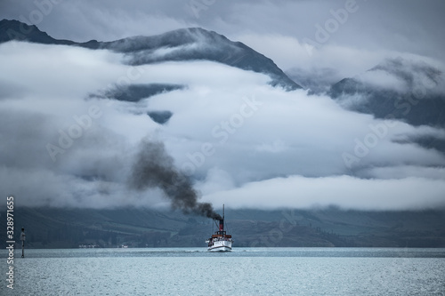 Boat on the lake Wakatipu in winter. Cloudy day. © Camille