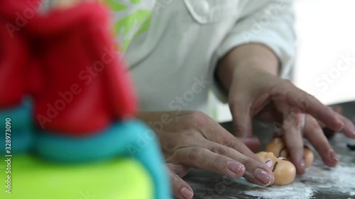 confectioner making figure from sugar paste fondant cake pastery photo