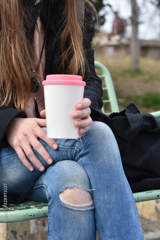 Female hand holding reusable coffee mug. Take your coffee to-go. Female hand holding reusable coffee mug. Take your coffee to-go.