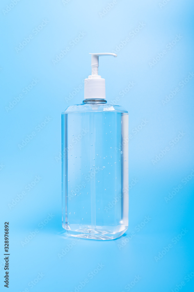 Hand sanitizer in plastic bottle isolated on blue background Hand sanitizer in plastic bottle isolated on blue background