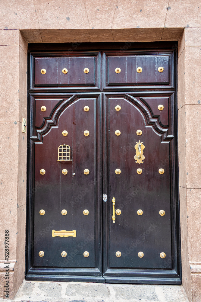 Fototapeta premium A beautifully kept old Dark wood door with brass studs 