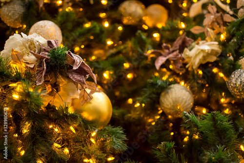 Shining Christmas tree with gold ornaments  © Jazmine