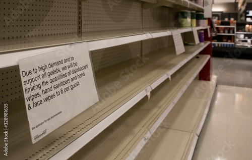 Empty shelves of cleaning supplies are accompanied by a sign limiting quantities. Inventory has plummeted as demand increases amid the coronavirus outbreak. photo