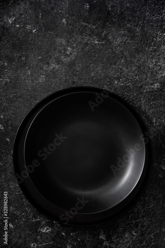 Simple composition of black plate on black background