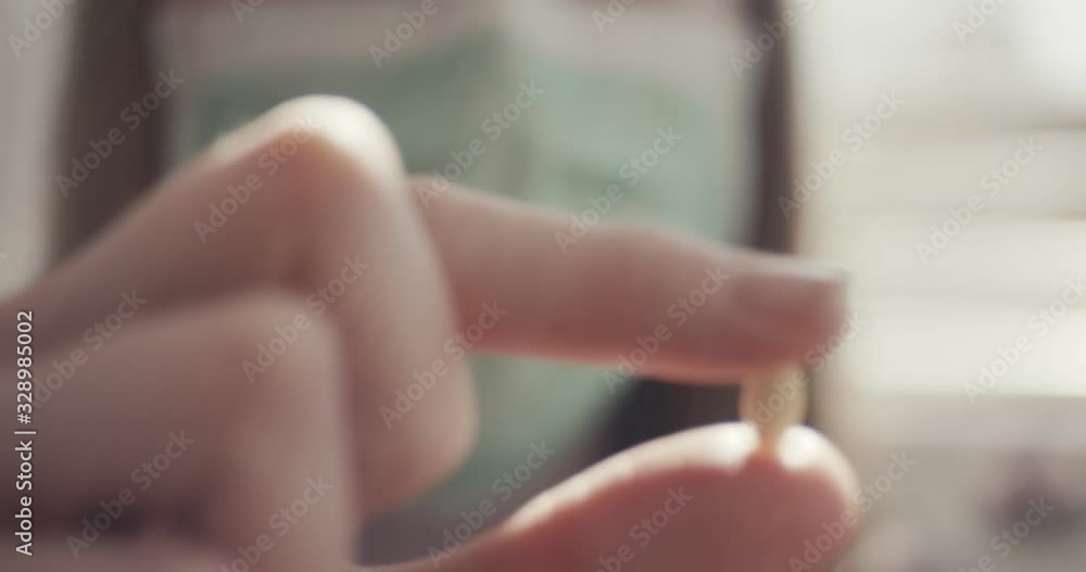 Woman shows pill face mask protection virus coronavirus at home quarantine macro close up unrecognizable Woman shows pill face mask protection virus coronavirus at home quarantine macro close up unrecognizable