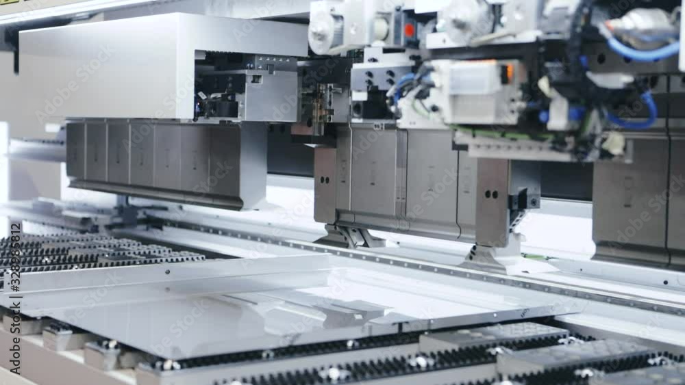 Automatic machine processing sheet metal in high tech workshop, parallax left Automatic machine processing sheet metal in high tech workshop, parallax left