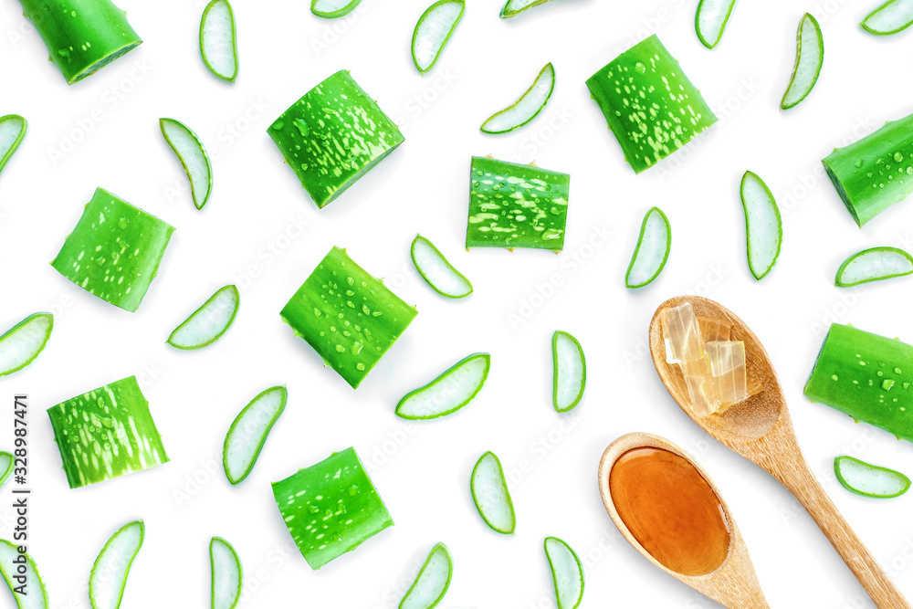 Green fresh aloe vera slices, aloevera gel and honey in wooden spoon isolated on white background. Natural herbal medical plant ,skin care ,health and beauty spa concept. Overhead view . Flat lay.
