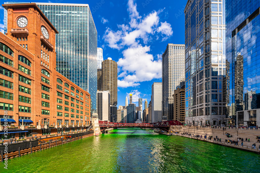 Chicago building and cityscape on Saint Patrick's day around Chicago river walk with green color dyeing river in Chicago Downtown, illinois, USA, crowned irish and american people are celebrating.