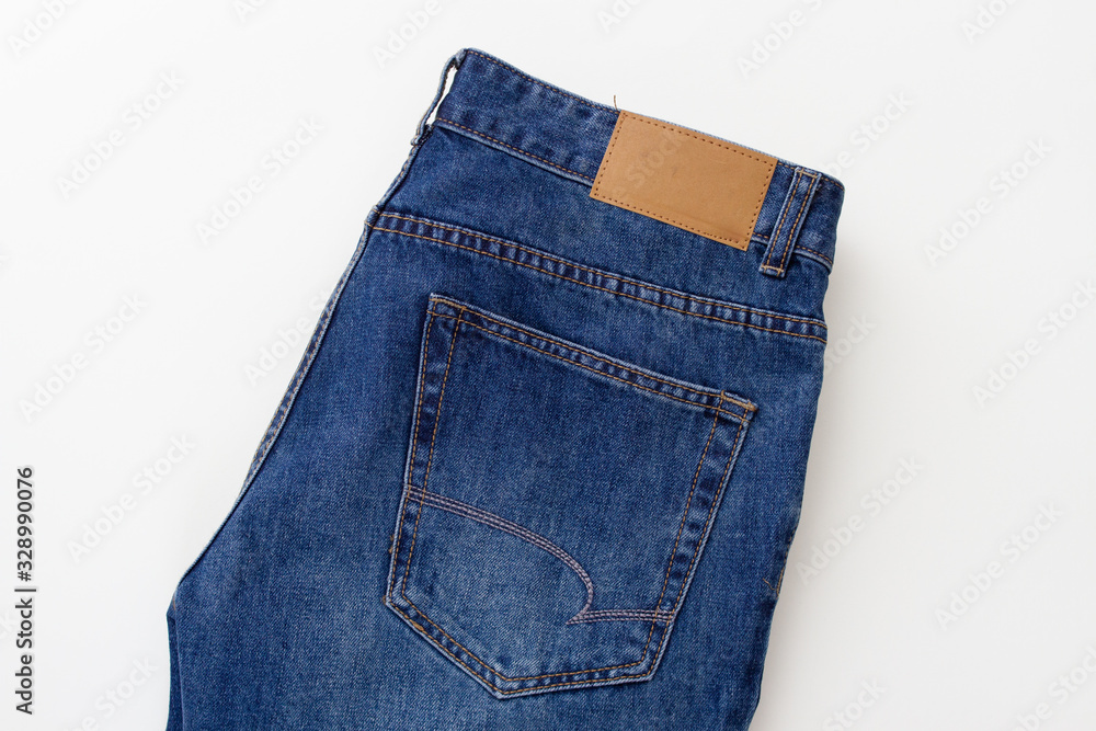 blue classic jeans with pocket and blank label on a white background blue classic jeans with pocket and blank label on a white background