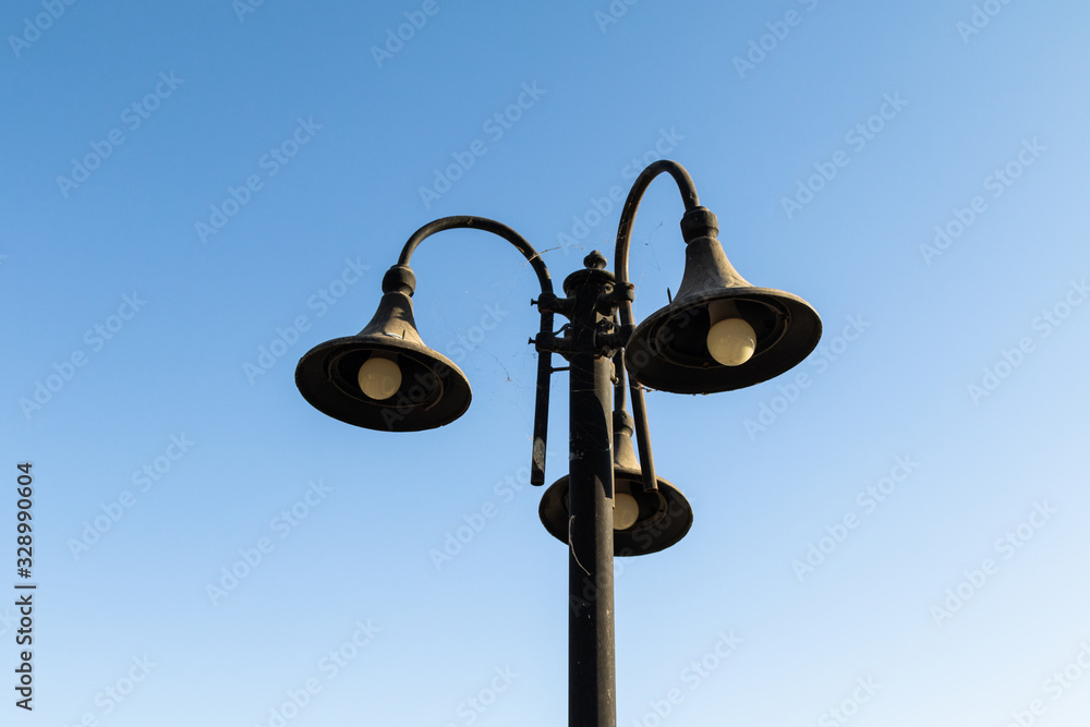 Street old lighting lamps on a sunny day. Street old lighting lamps on a sunny day.