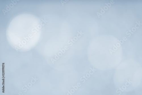 Abstract bokeh sparkle on light blue background
