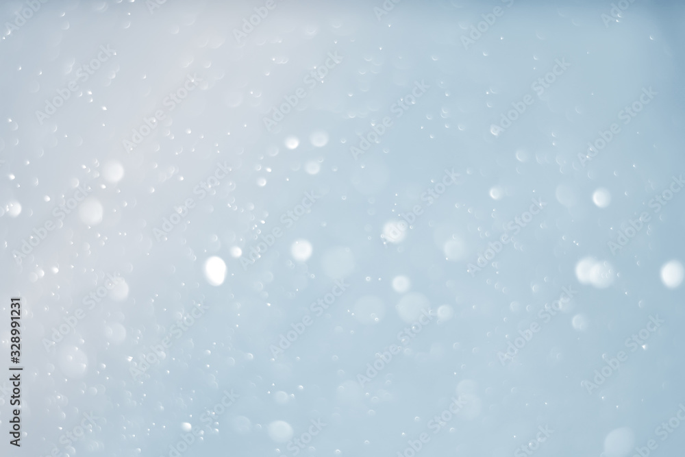 Abstract bokeh sparkle on light blue background Abstract bokeh sparkle on light blue background