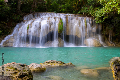  Erawan Waterfall water is emerald  in green forest
