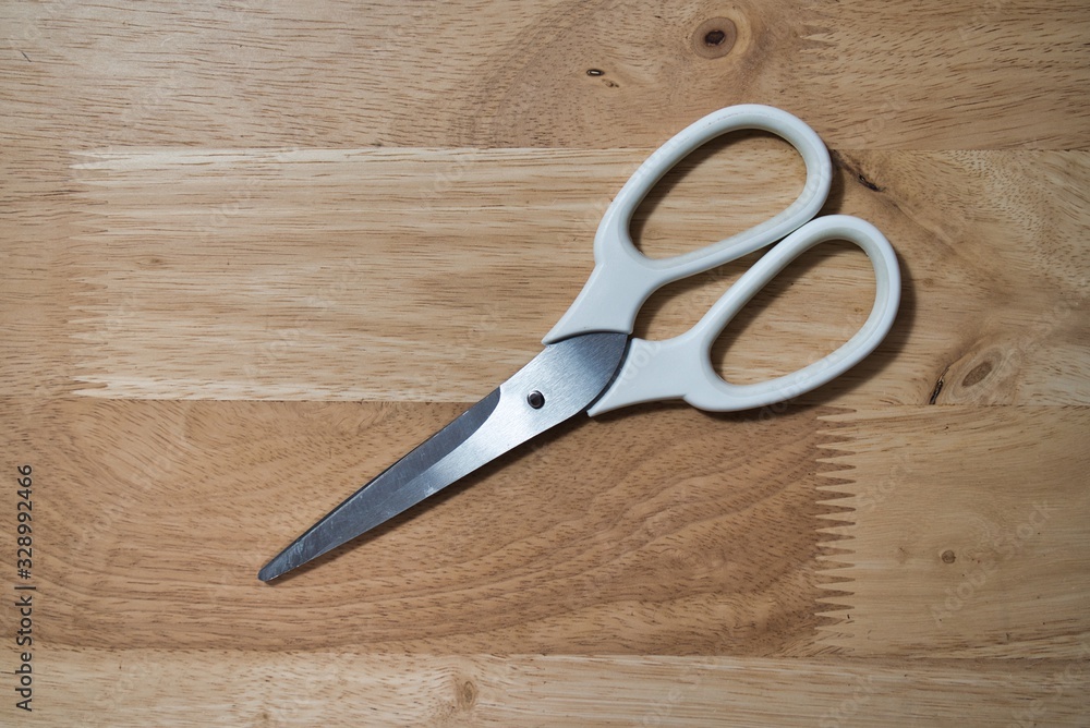 scissors on wooden background scissors on wooden background