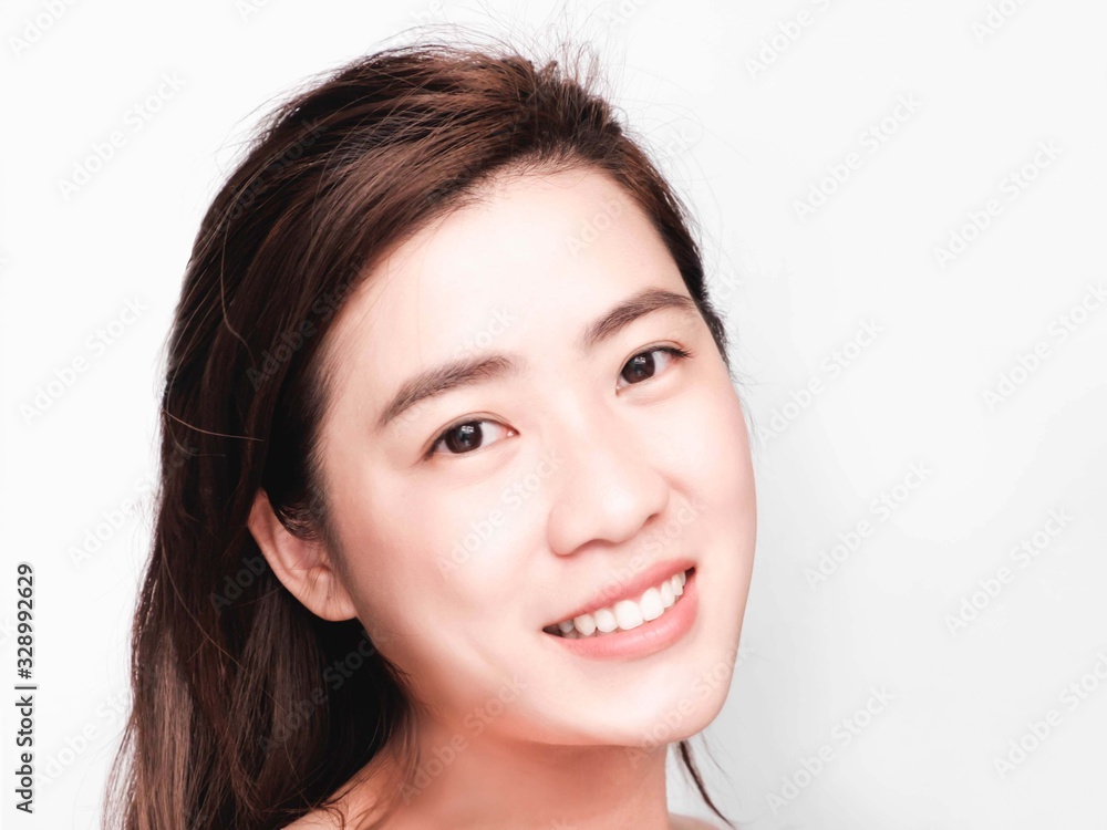 young beautiful asian woman with clean and bright skin, Cosmetic Beauty Concept,hands touch on the cheek, smiling and friendly face isolated on grey background young beautiful asian woman with clean and bright skin, Cosmetic Beauty Concept,hands touch on the cheek, smiling and friendly face isolated on grey background