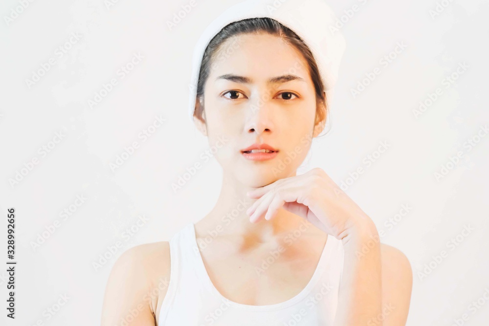 young beautiful asian woman with clean and bright skin, Cosmetic Beauty Concept,hands touch on the cheek, smiling and friendly face isolated on grey background young beautiful asian woman with clean and bright skin, Cosmetic Beauty Concept,hands touch on the cheek, smiling and friendly face isolated on grey background