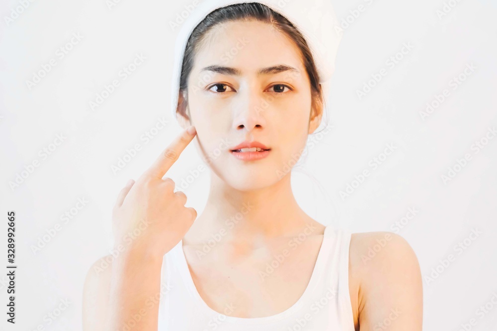 young beautiful asian woman with clean and bright skin, Cosmetic Beauty Concept,hands touch on the cheek, smiling and friendly face isolated on grey background young beautiful asian woman with clean and bright skin, Cosmetic Beauty Concept,hands touch on the cheek, smiling and friendly face isolated on grey background