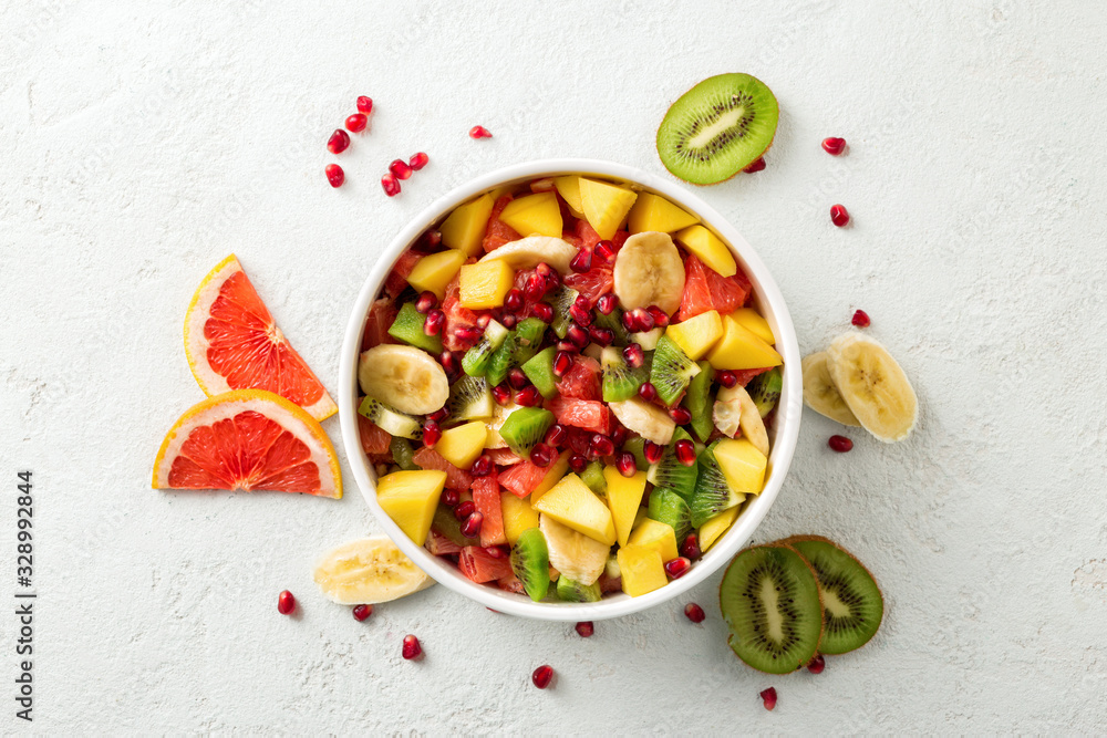 Ταπετσαρία Fresh fruit salad on light surface top view Summer food concept