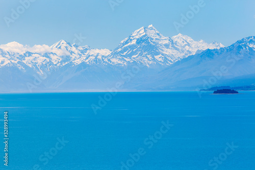 Azure coloured waters of Lake Pukaki with mighty Mt Cook on the horizon, South Island, New Zealand