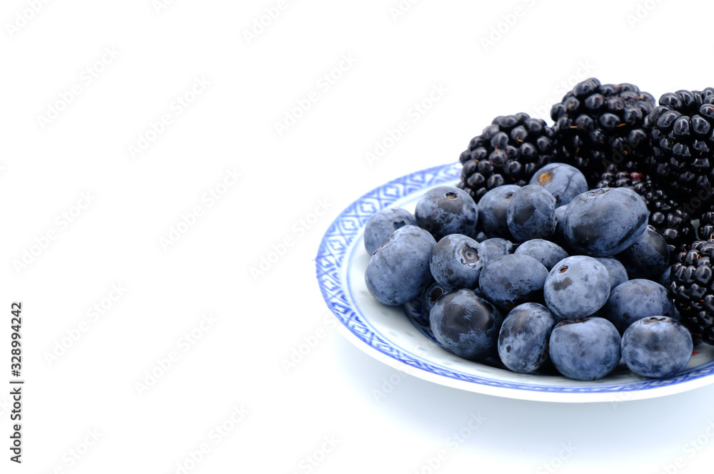 Blueberry and Blackberry on blown cup with white background, fruit concept Blueberry and Blackberry on blown cup with white background, fruit concept