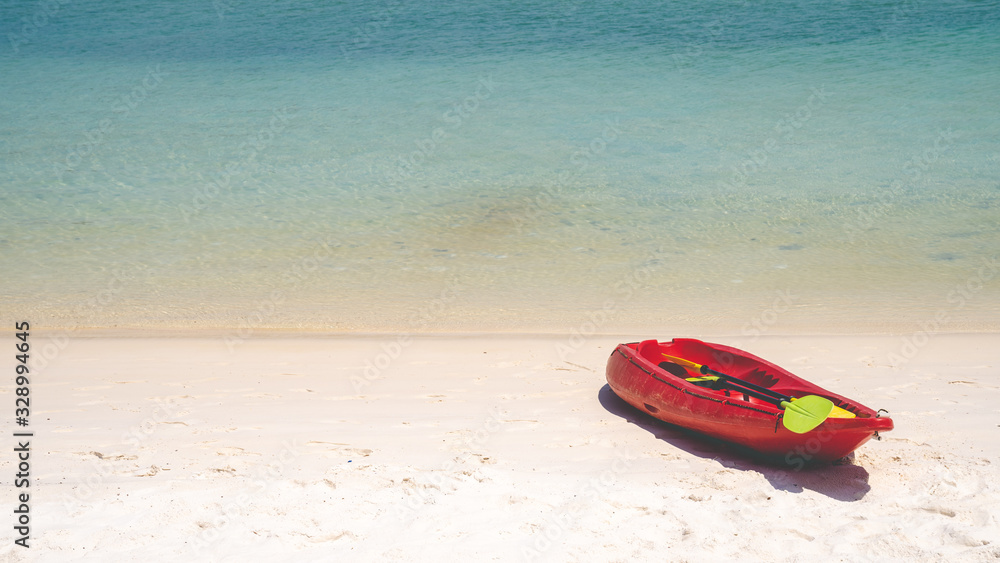 Kayaks and paddles on the beautiful beach by the sea Kayaks and paddles on the beautiful beach by the sea