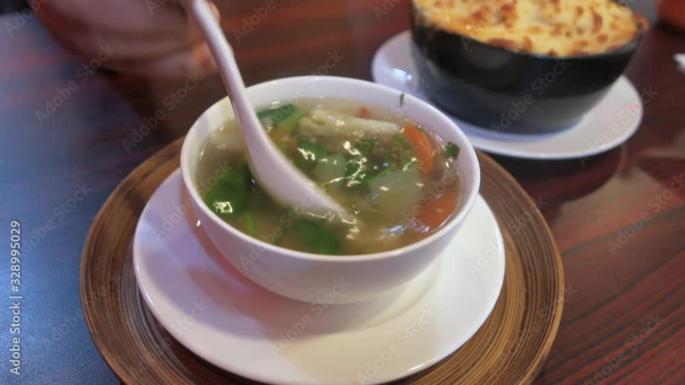 Close up of vegetable soup in a bowl on table Close up of vegetable soup in a bowl on table