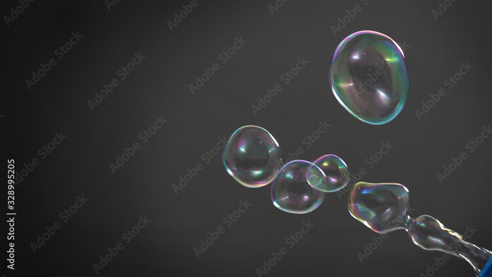 Soap or shampoo bubbles floating in the air by wind blow which represent refreshing and relaxing or joyful mood and tone and shoot in clear background in studio lighting set.