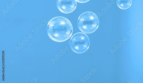 Soap or shampoo bubbles floating in the air by wind blow which represent refreshing and relaxing or joyful mood and tone and shoot in clear background in studio lighting set.